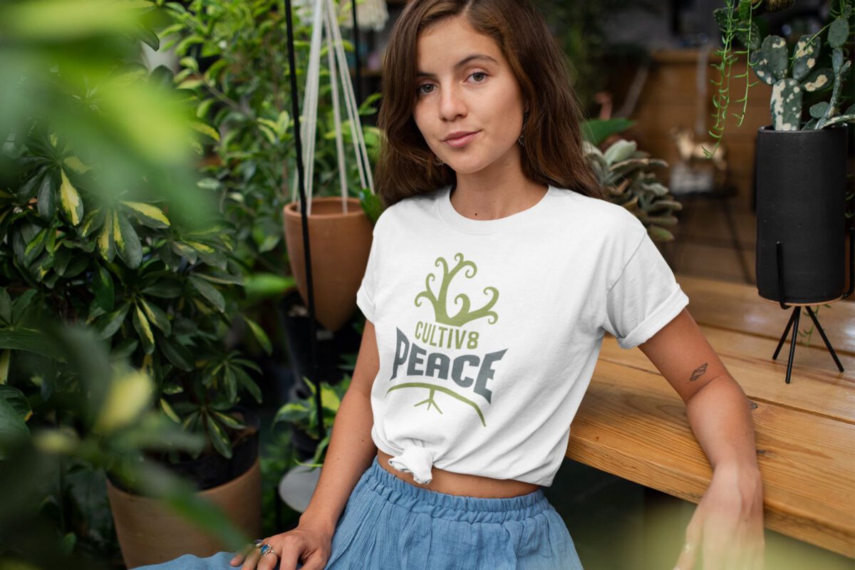 Women in her garden wearing a cultivate peace shirt