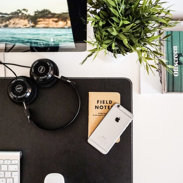 Office desk with headphones and field notes